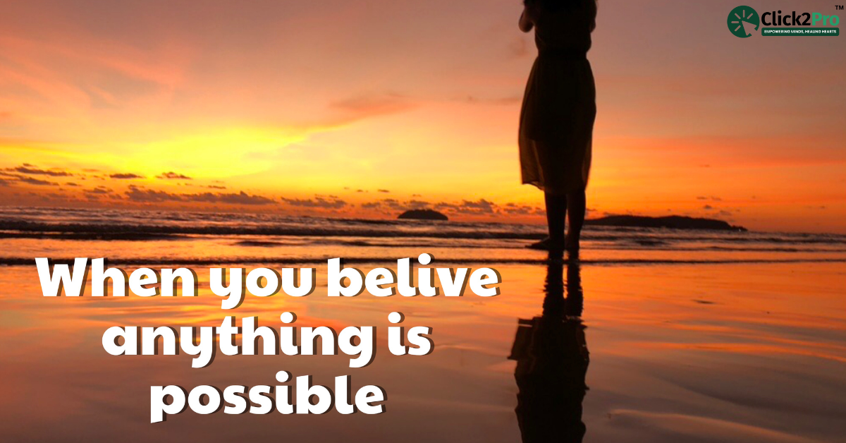 Silhouette of a person by the ocean at sunset with text 'When you believe anything is possible'.