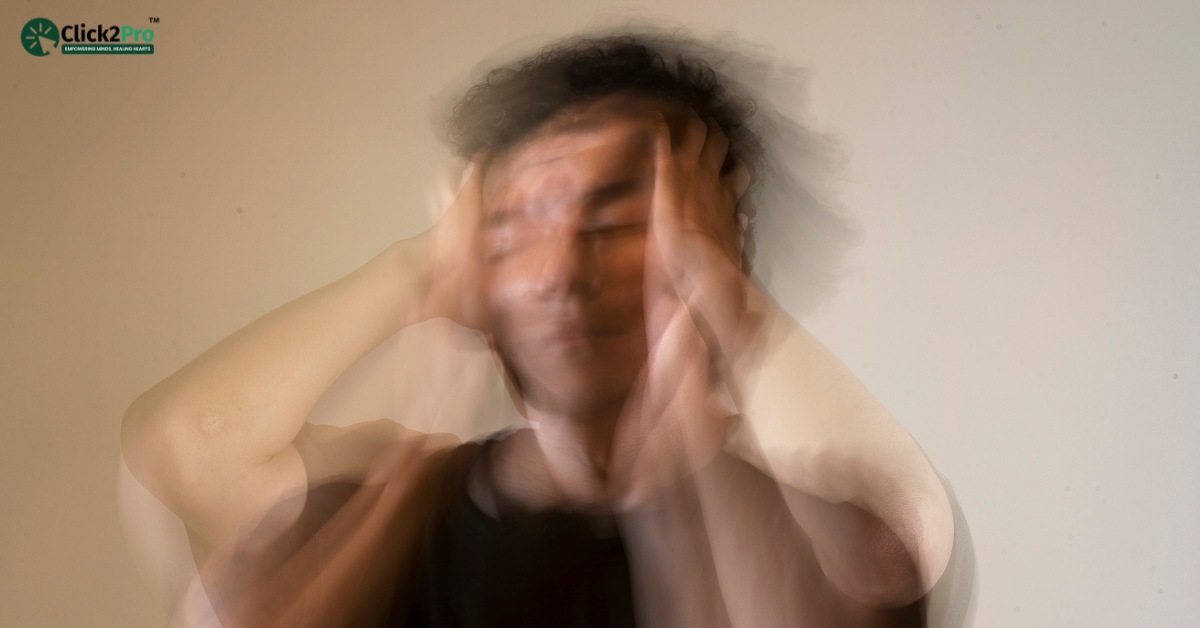 Blurred image of a distressed person holding their head, depicting double depression symptoms.