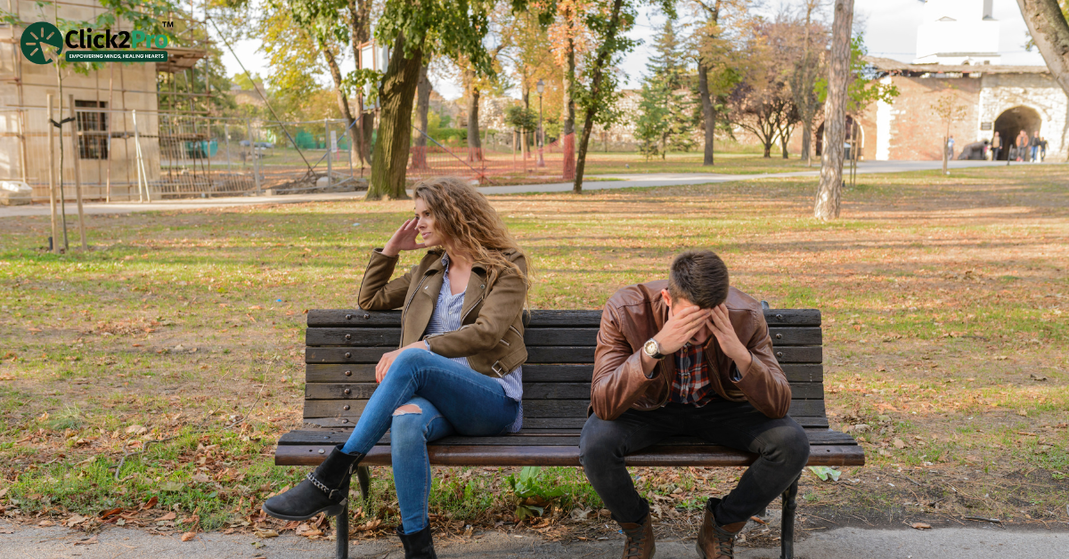 Couple experiencing relationship issues on a park bench, highlighting the concept of dating benching.