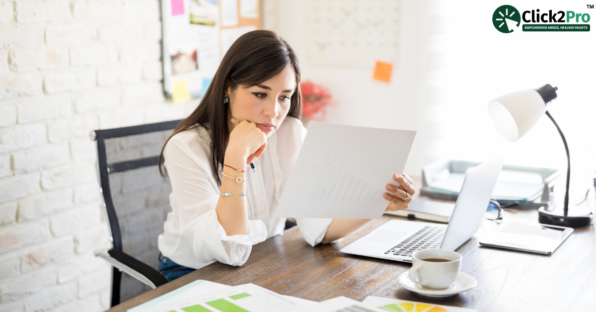 Woman analyzing data on paper while sitting at desk with laptop and coffee.