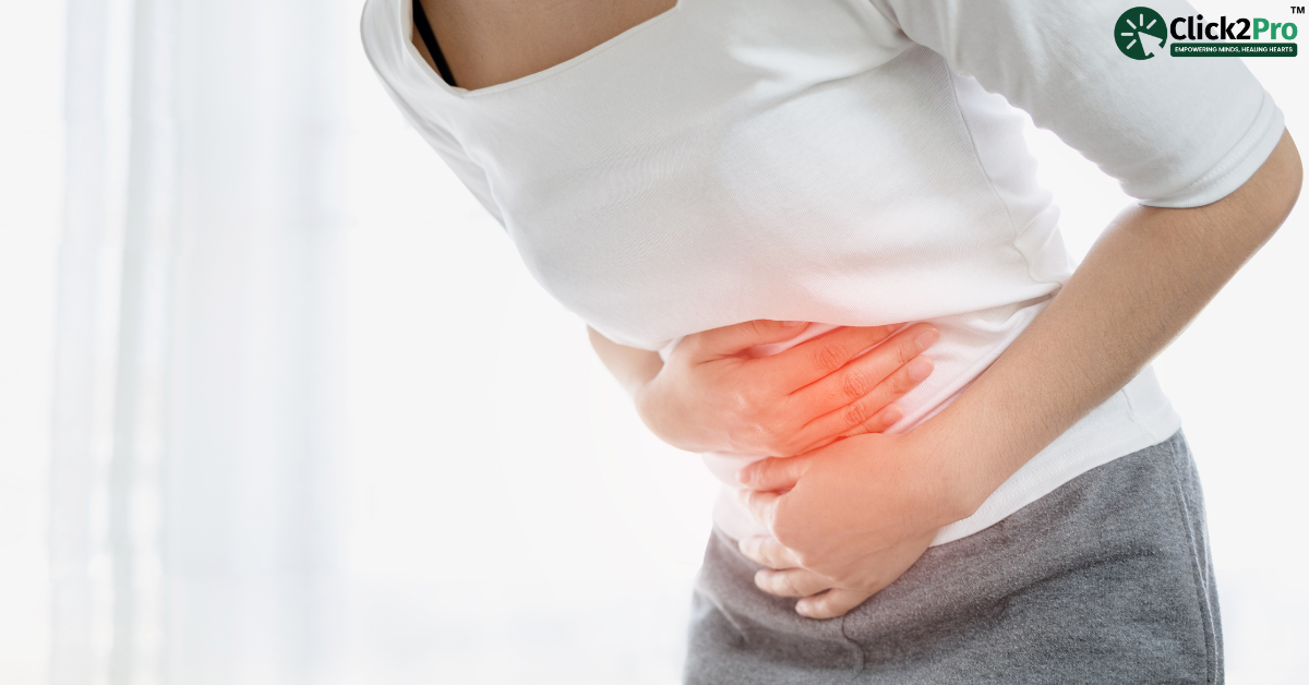 Person holding stomach in pain, representing symptoms of PMDD, discussed in therapy management blog.