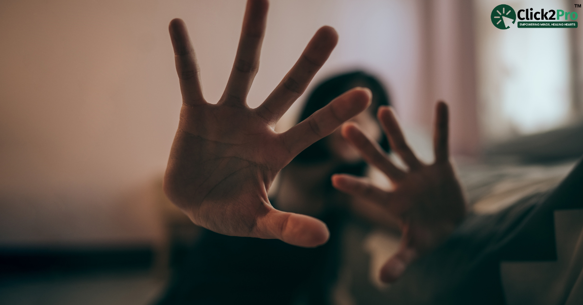 Person experiencing fear or anxiety, covering face with hands, illustrating social phobia.