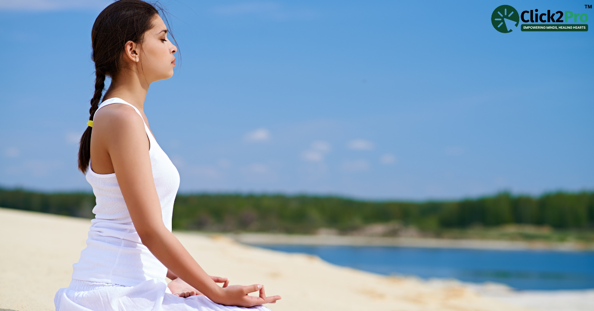 Person practicing stress-relief through meditation and body language techniques by a serene lakeside