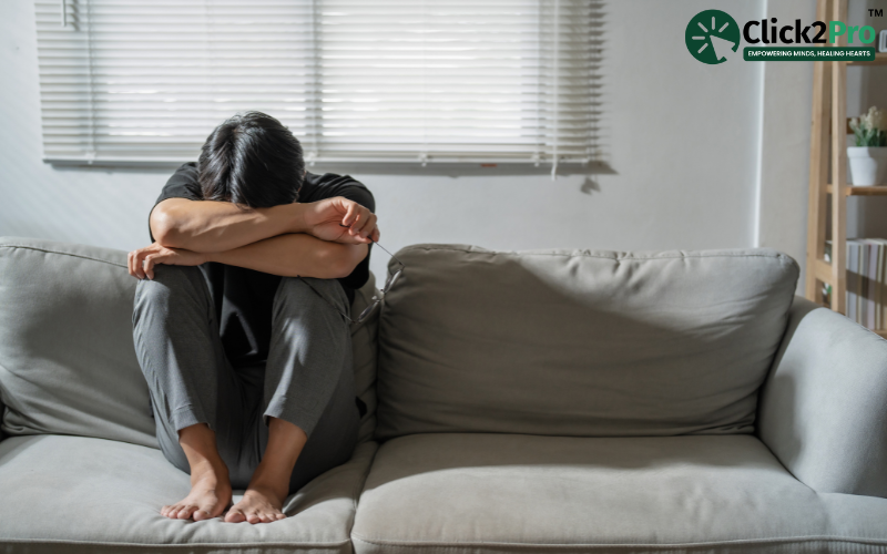 Person experiencing emotional distress on a sofa, symbolizing mental health struggles and Histrionic Personality Disorder.