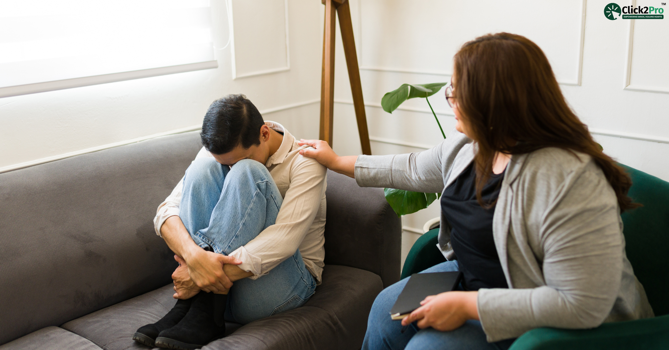 Therapist comforting a distressed man during a mental health session at Click2Pro.