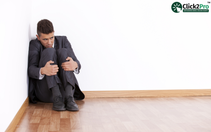 Man sitting anxiously in a corner, symbolizing fear; VR therapy for safe fear confrontation and recovery.