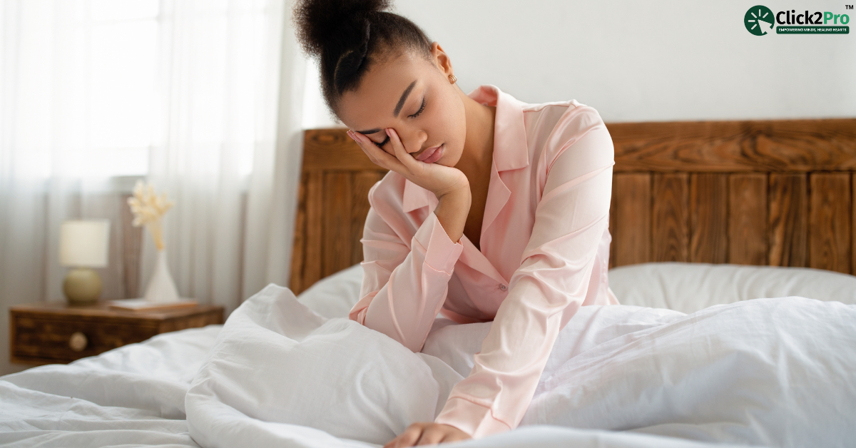 Person struggling with fatigue in bed, symbolizing symptoms of Seasonal Affective Disorder (SAD).