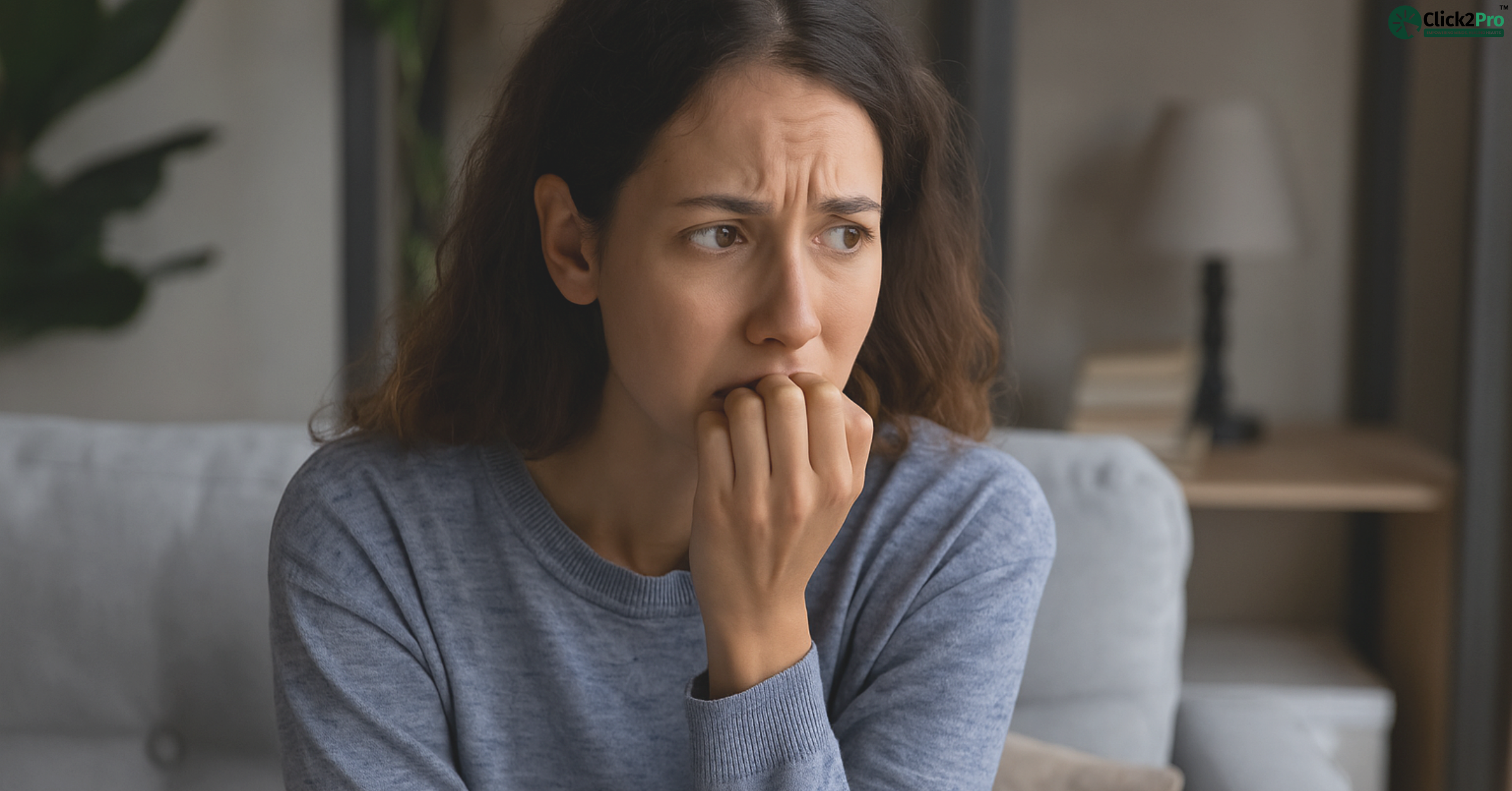 Woman feeling anxious and biting nails, showing signs of anticipatory anxiety disorder.