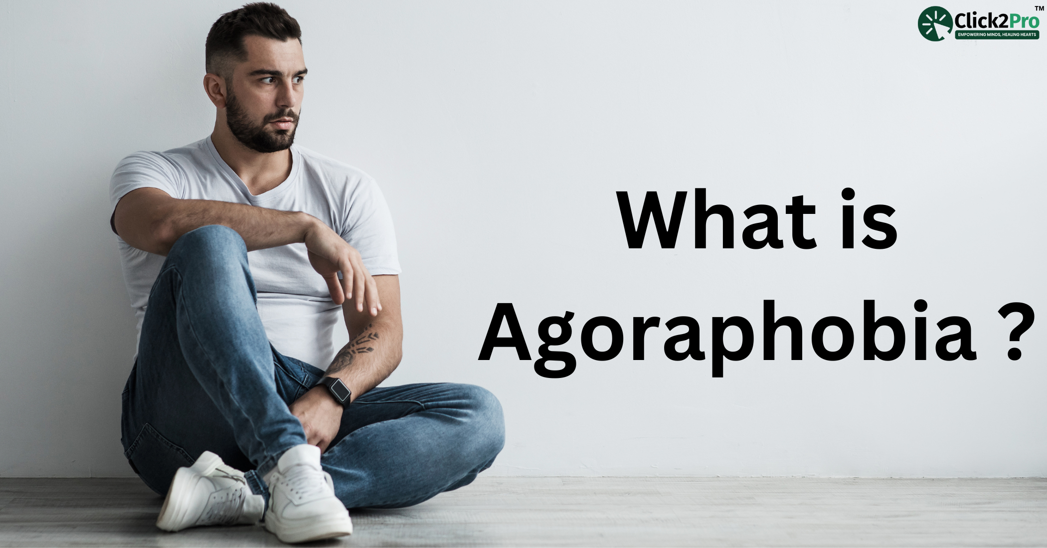 Man sitting against a wall experiencing anxiety, representing agoraphobia and its challenges.