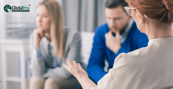 Couple in a therapy session discussing issues with a professional, highlighting benefits of sex therapy.